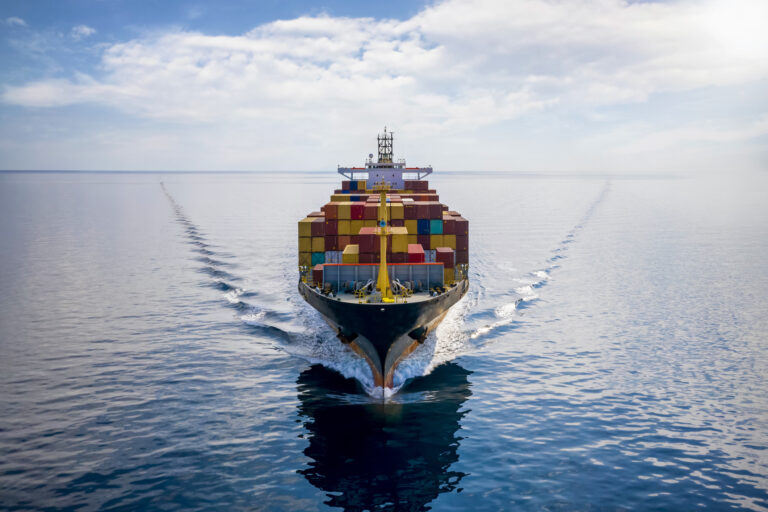 Aerial front view of a loaded container cargo vessel